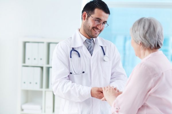 young-doctor-supporting-his-patient_1098-2237